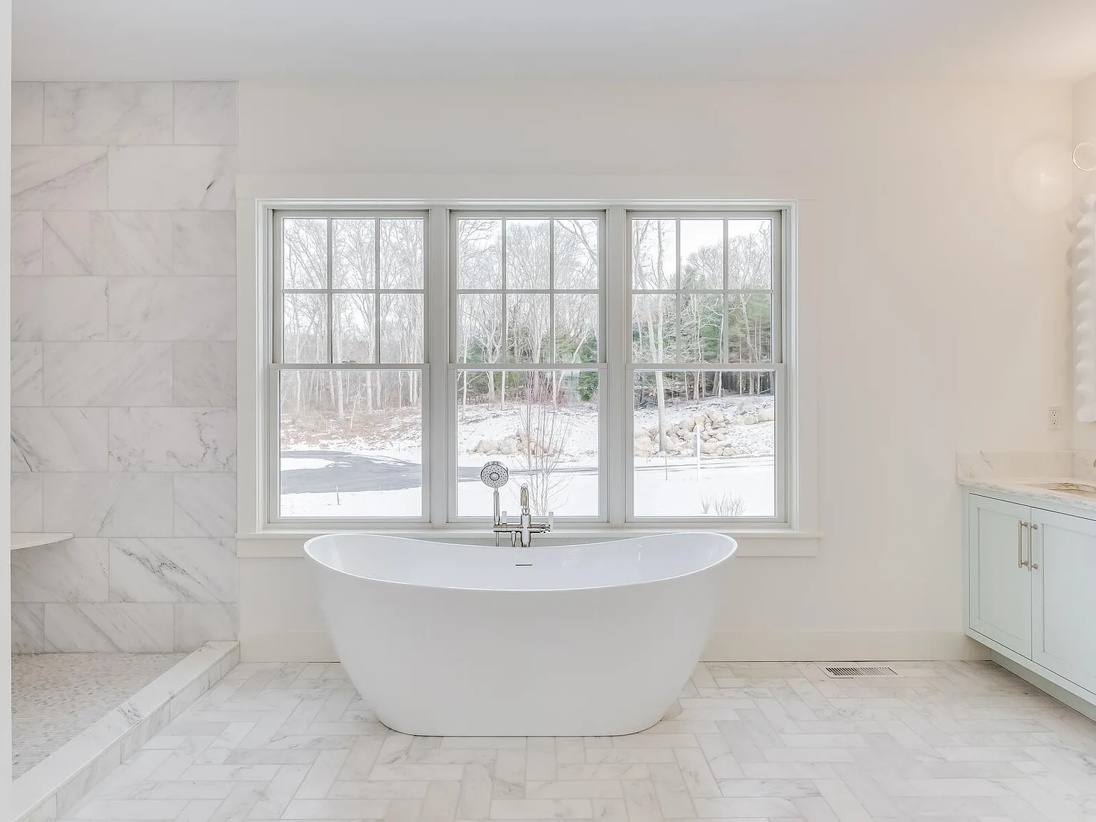 Primary bath — freestanding soaking tub, full marble walls and floors, Andersen windows